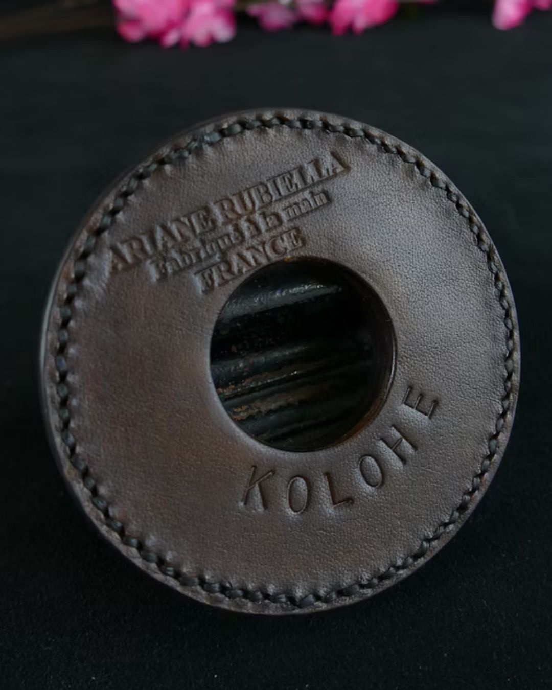 Brown leather patch with 'Kolore' branding on a black background